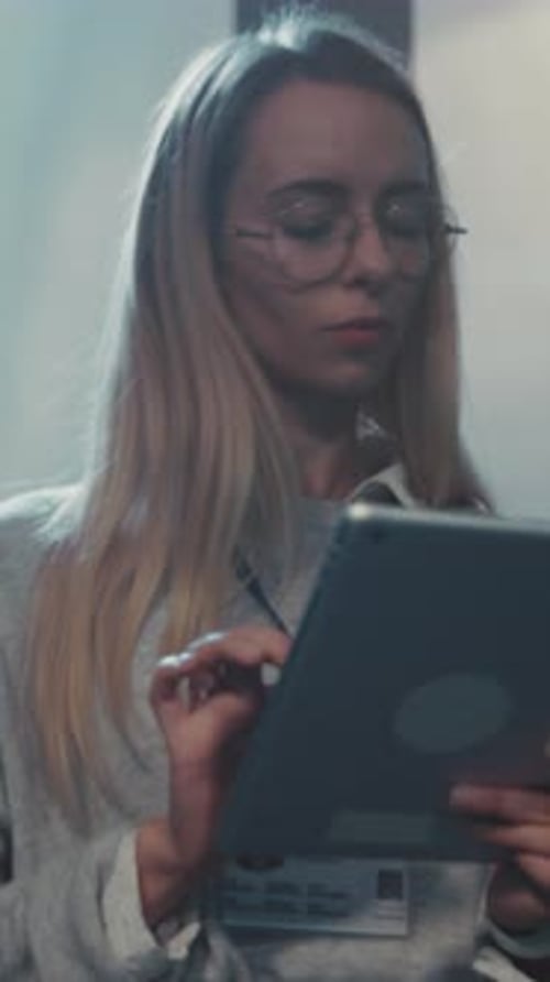 Female Analyst Working Female Technician Uses Touchscreen to Verify Server Status in Dimly Lit