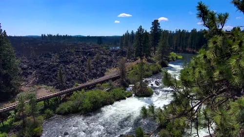 Aerial reveal of whitewater rapid river on a clear sunny day 4K Slow Motion