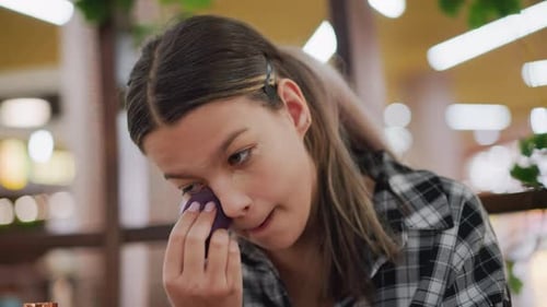 Young Woman Applying Makeup with Sponge Indoors