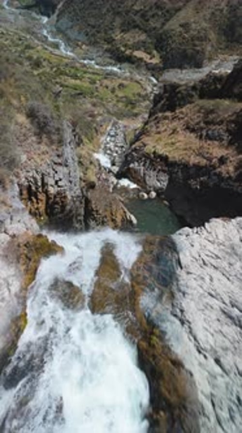 Aerial View of Waterfall in Mountainous Landscape