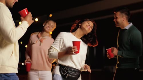 Group of Young Adults Dancing at Night Party