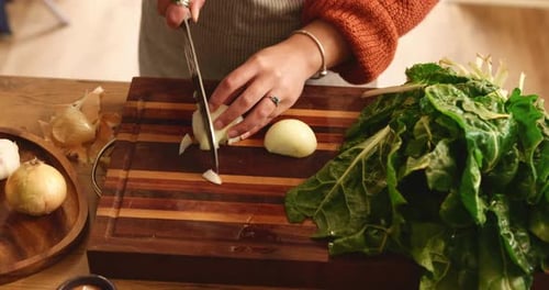 Woman Chopping Onion on Cutting Board