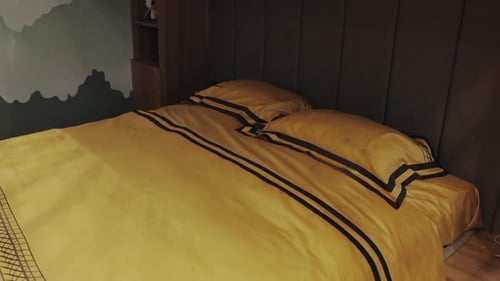 Comfortable Bed with Gold Comforter and Pillows
