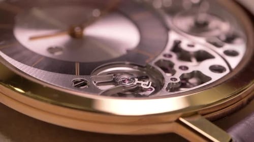 Close up on luxurious rotating mechanical Piaget wristwatch clockwork timepiece craftsmanship detail
