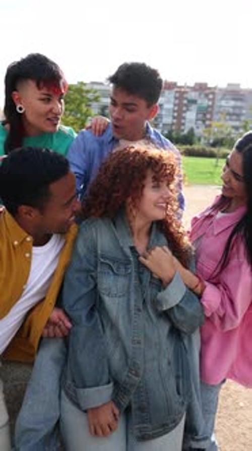 Multicultural young friends sharing genuine moments of laughter, hugging, and creating playful expre