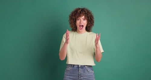 Woman Surprised on Green Background