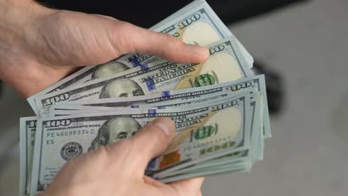 Hands Counting Stack of Hundred Dollar Bills