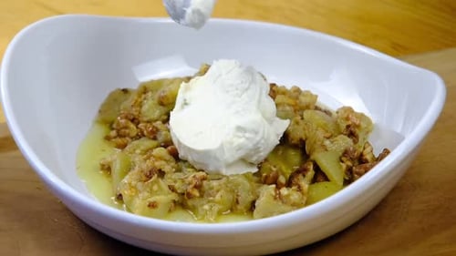 the chef puts yogurt on the food in the plate