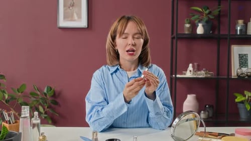 Woman Shares Makeup Tips at Table Indoors