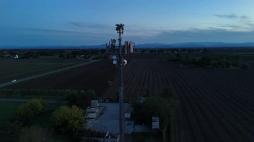 Cellular data antenna tower transmitting wireless communication signals across a rural landscape