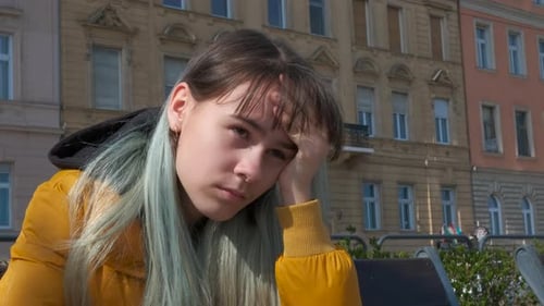 Adolescent d'humeur triste sur un banc de ville