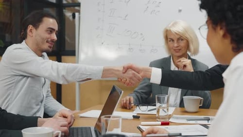 Business People Shake Hands During Productive Meeting