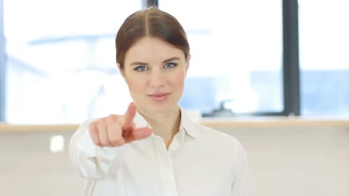 Pointing Toward Camera Woman in Office