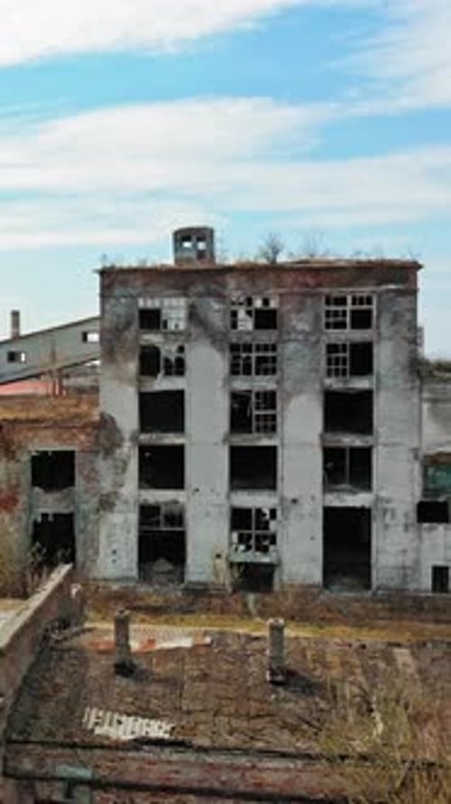 Aerial view of an old factory ruin and broken windows. Old industrial building for demolition