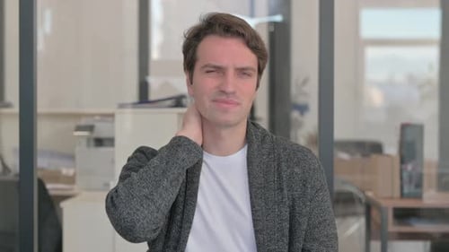 Man Massaging Neck in Office Close Up