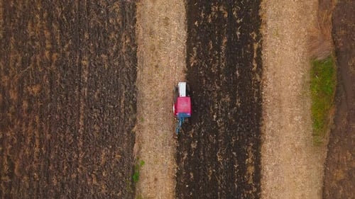 Farm Tractor Plowing Field