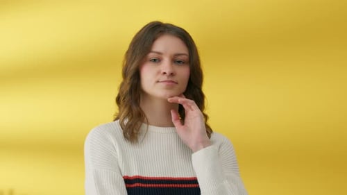 Young Woman Smiling Portrait on Yellow Background