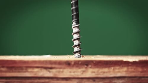Drilling Black Screw into Wood Plank Close Up