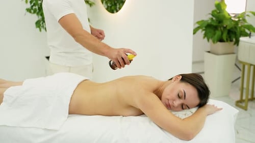 Woman Receiving Relaxing Back Massage in Spa Setting