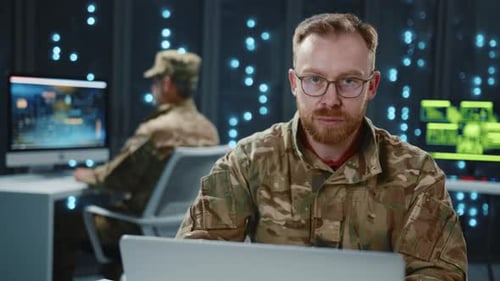 Men in Uniforms Typing in Server Room