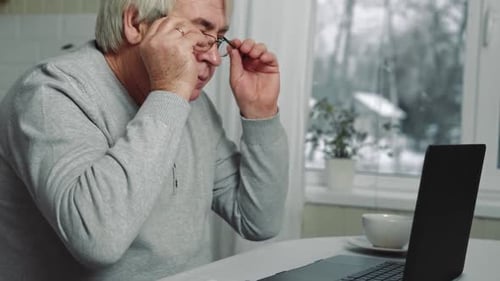 Busy Tired Old Man Using Laptop Working From Home