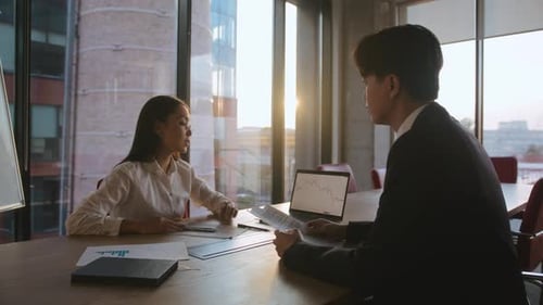 Business People Analyzing Data in Sunny Office