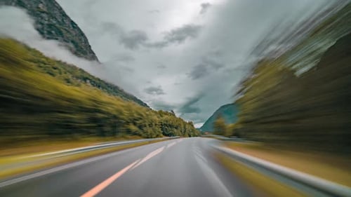 Dashcam view. Driving on the narrow rural road and then through the streets of the Sunndalsora, Norw