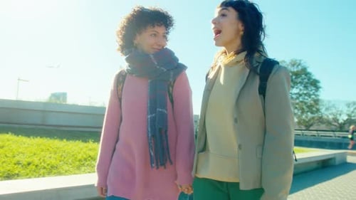 Young Lesbian Girlfriends Holding Hands on a Walk Outdoors