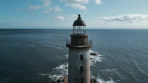 Top view of abandoned lighthouse with sea waves