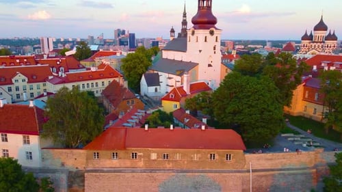 Panning aerial movement about the downtown of Tallinn with churches at sunset, Estonia.