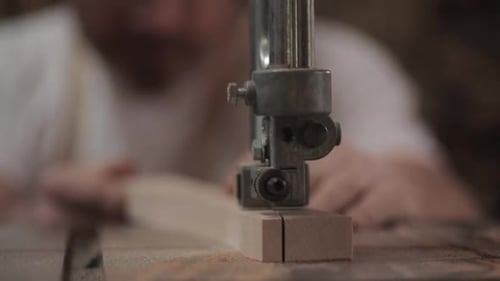 Carpenter skillfully cutting wood block with jig saw in calgary alberta Canada