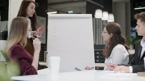 Confident Woman Leader Trains Colleagues in Modern Office Businesswoman in Suit Talking at Team