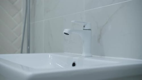 Close Up of White Sink with Chrome Faucet