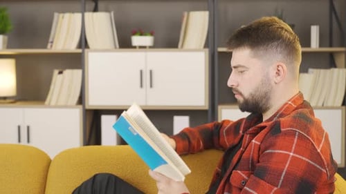 Man Relaxing at Home Reading a Book