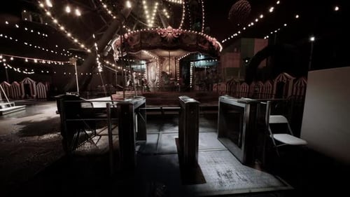Empty Amusement Park at Night with Illuminated Attractions and Quiet Pathways