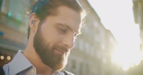 Sunlight Day Summertime Close Up of Young Handsome Male Traveler Holding Smartphone Looking at