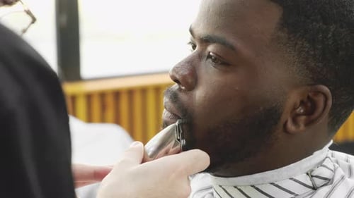 Young Man Getting Beard Trim at Barbershop