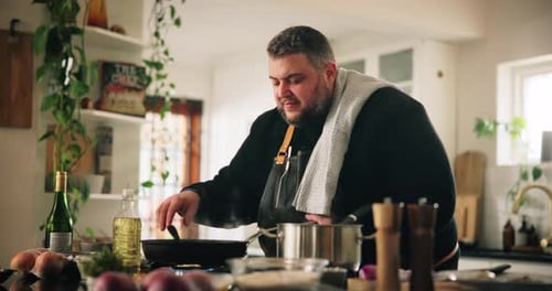 Man Cooking Food in Kitchen at Daytime
