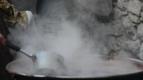 peasant woman boiling pomegranate syrup