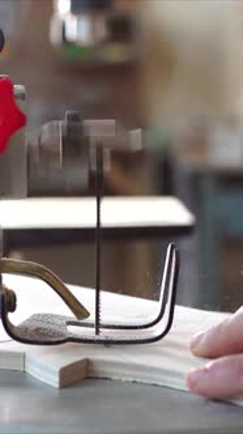 Cutting Wood with Scroll Saw in Vertical Format