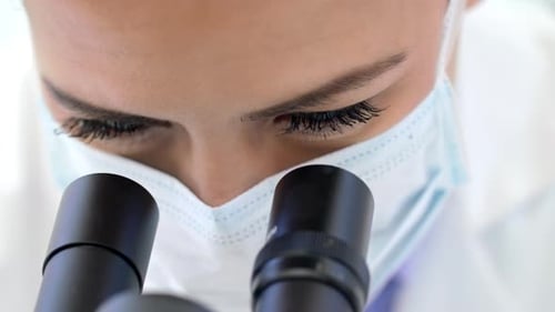 Scientist Uses Microscope in Lab Research