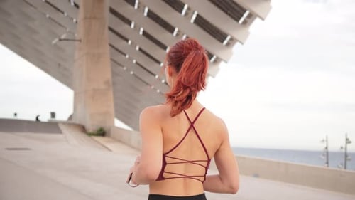 Athletic Woman Jogging Outdoors on Sunny Day