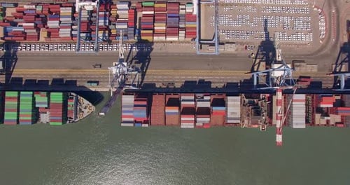 Commercial port with container ships - Top down aerial view.