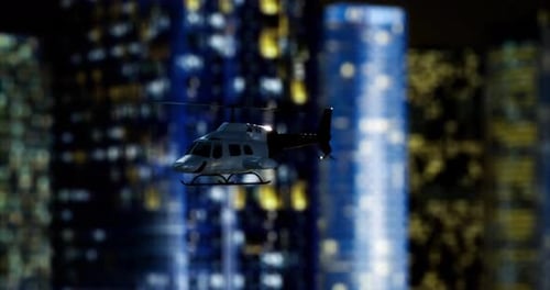 Helicopter Hovering Over a City Skyline at Night with Illuminated Buildings