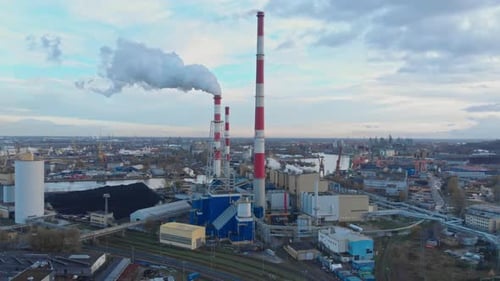 A Factory With Smoke Coming Out of It's Stacks