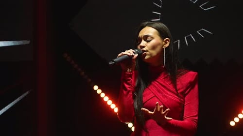 Female Singer Performing on Stage at Night