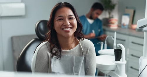 Woman Smiling in a Dentist Chair at Clinic