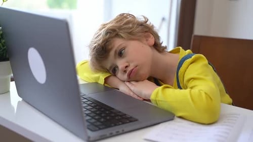 Child Looks At Laptop At Home