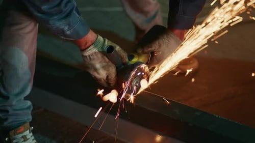 Angle Grinder Sparks Fly During Metal Shaping Heavyduty Gloves and Precise Stance for Steel Beam