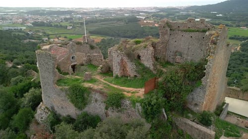 Ruined castle in Europe aerial footage cinematic medieval era Aerial views of Palafolls castle in Ba
